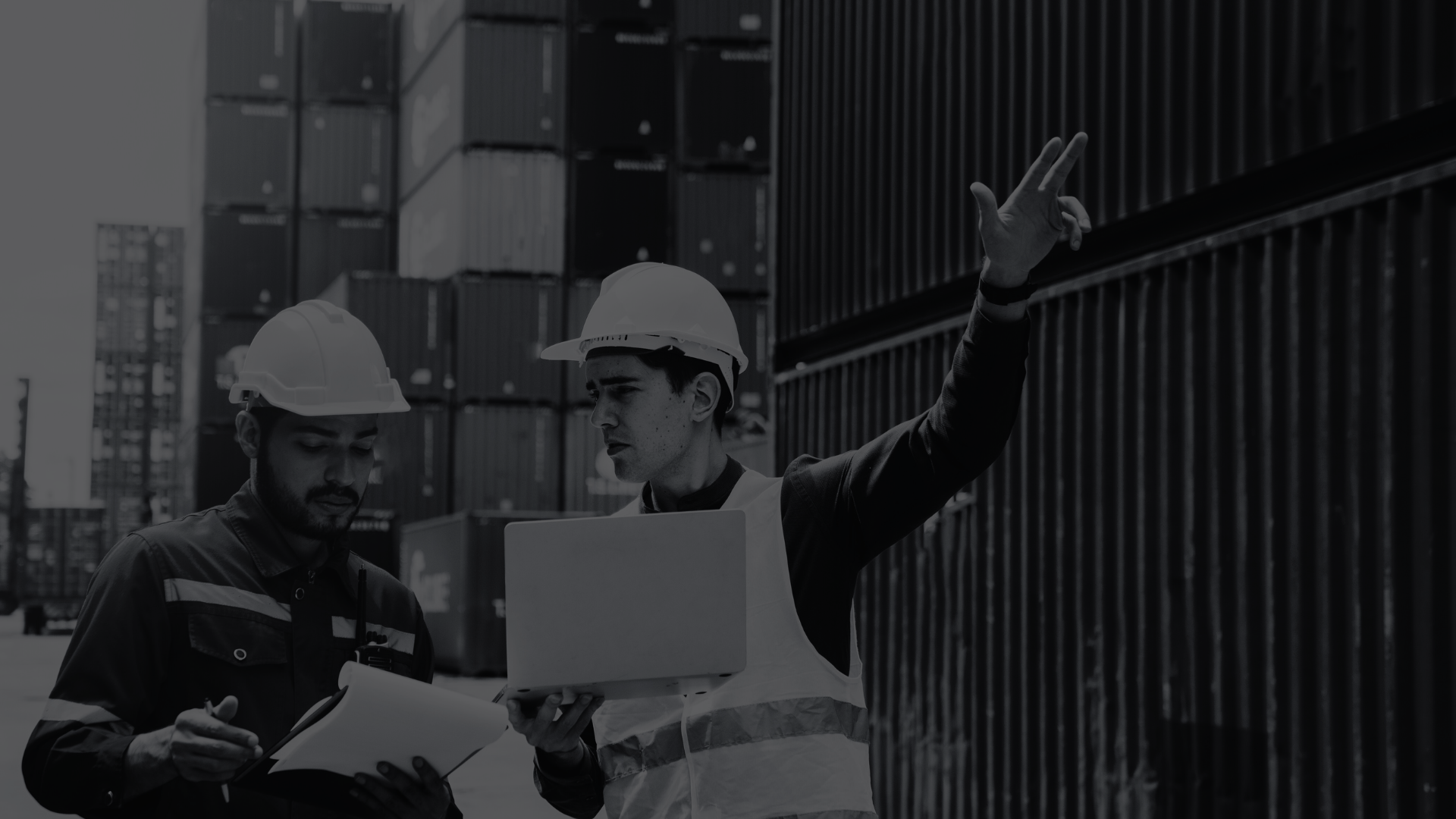 People in hard hats at a shipping dock